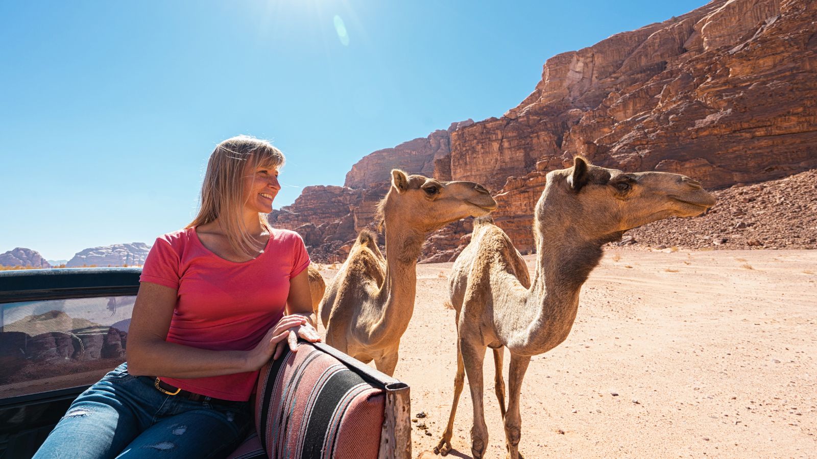 woman-with-camels-in-desert