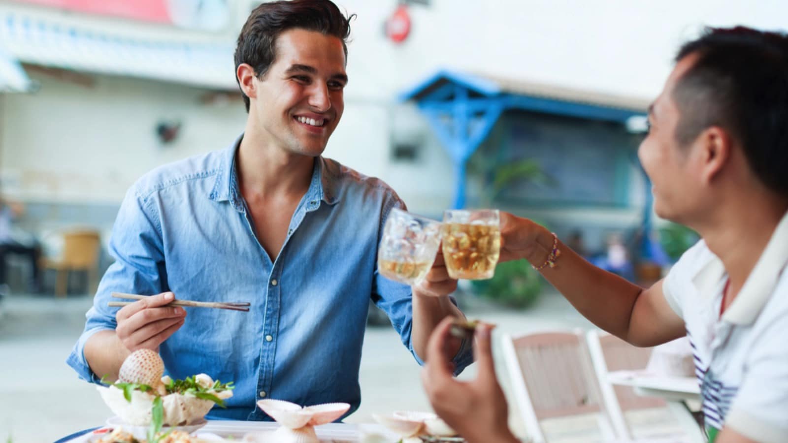 Traveler-giving-toast-with-local-man