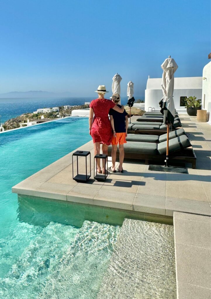 mother and son looking out at ocean in mykonos greece